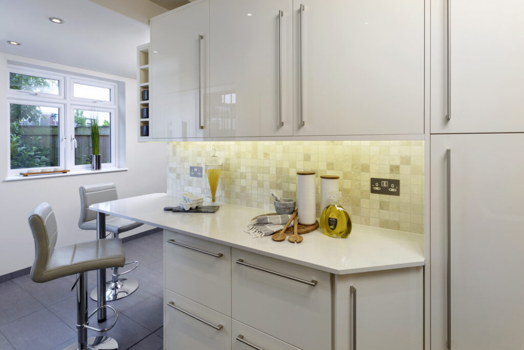 Professional kitchen installation in Arkley featuring a kitchen extension and a high gloss kitchen as the main focal points.
