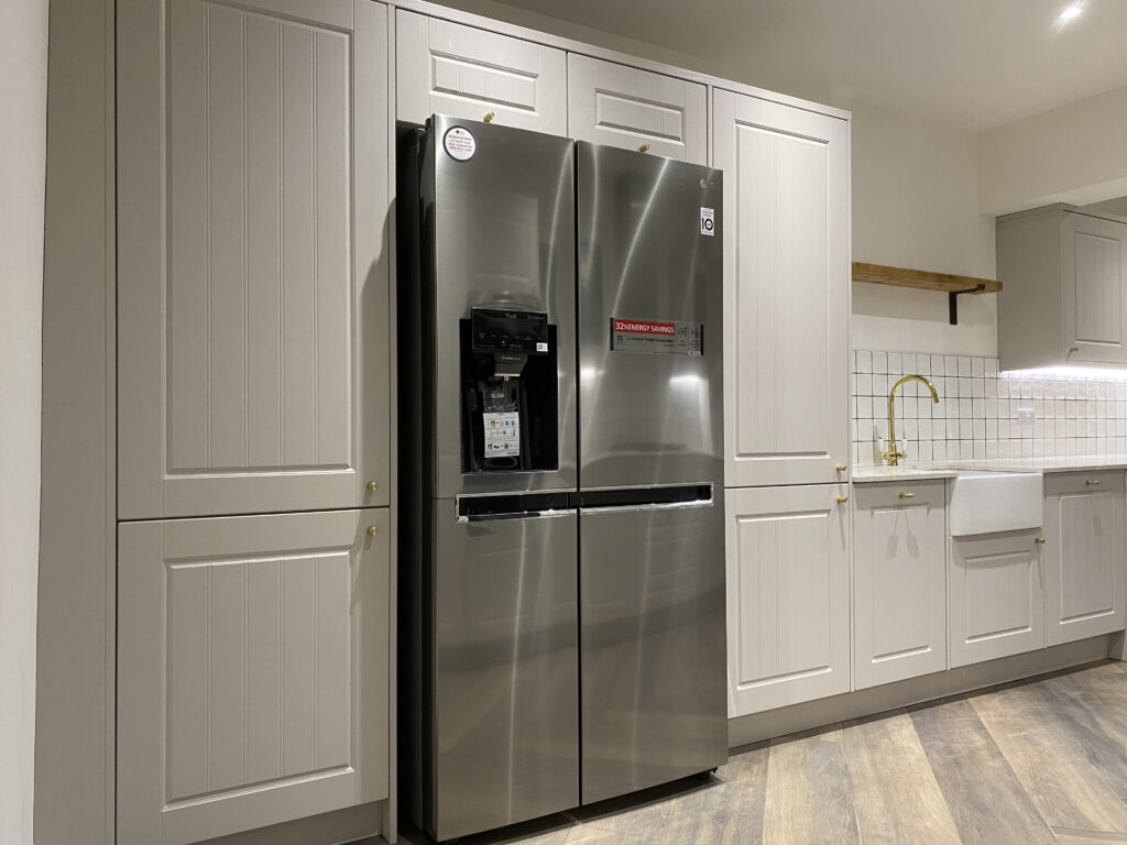 Professional kitchen installation in Totteridge featuring a freestanding fridge freezer and a shaker kitchen as the main focal points.
