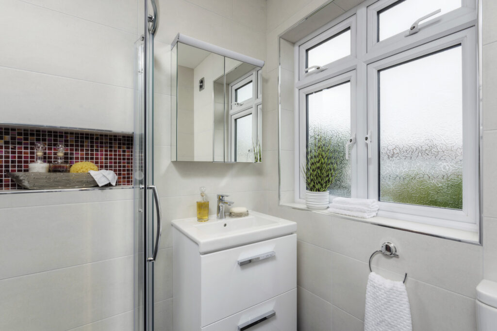 Professional bathroom installation in Mill Hill featuring a mirror cabinet and a vanity unit as the main focal points