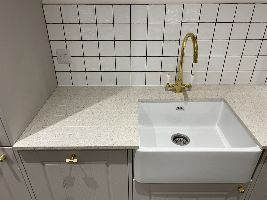 Professional kitchen installation in Totteridge featuring a belfast sink and a gold kitchen tap as the main focal points.