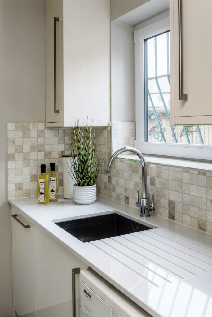 Professional kitchen installation in Arkley featuring a mosaic tiles and a quartz worktop as the main focal points.