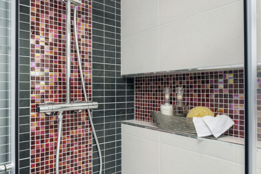 Professional bathroom installation in Mill Hill featuring a shower valve and a shower niche as the main focal points