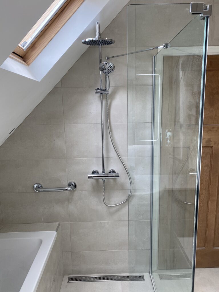 Professional wet room installation in Totteridge featuring an expose shower and a walk in shower screen as the main focal points