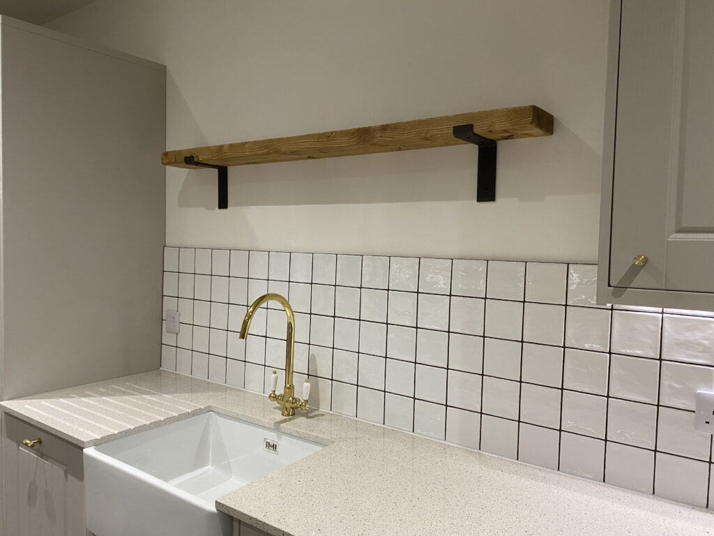 Professional kitchen installation in Totteridge featuring a wood shelve and a square tiles as the main focal points