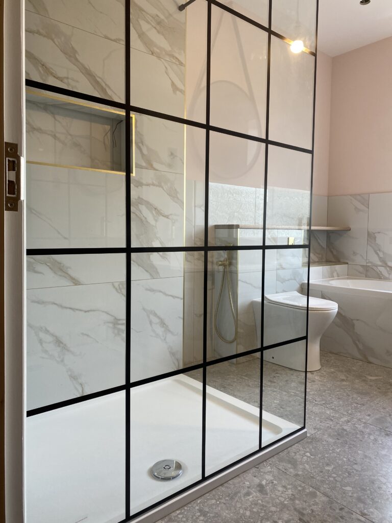 Professional bathroom installation in Hadley Wood featuring a black shower screen and a rectangle shower tray as the main focal points