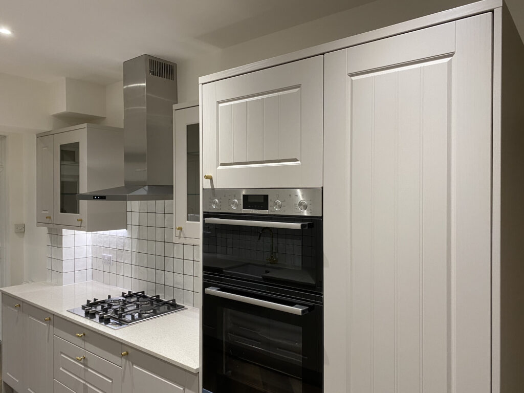 Professional kitchen installation in Totteridge featuring a double oven and a gas hob as the main focal points