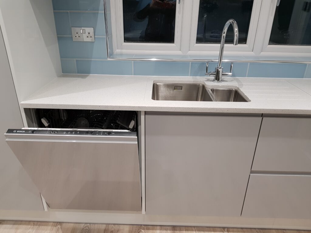 Professional kitchen installation in Mill Hill featuring an integrated dishwasher and an under mount sink as the main focal points