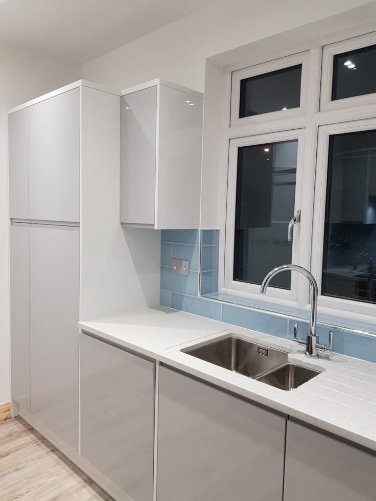 Professional kitchen installation in Mill Hill featuring a tall kitchen units and a metro tiles as the main focal points