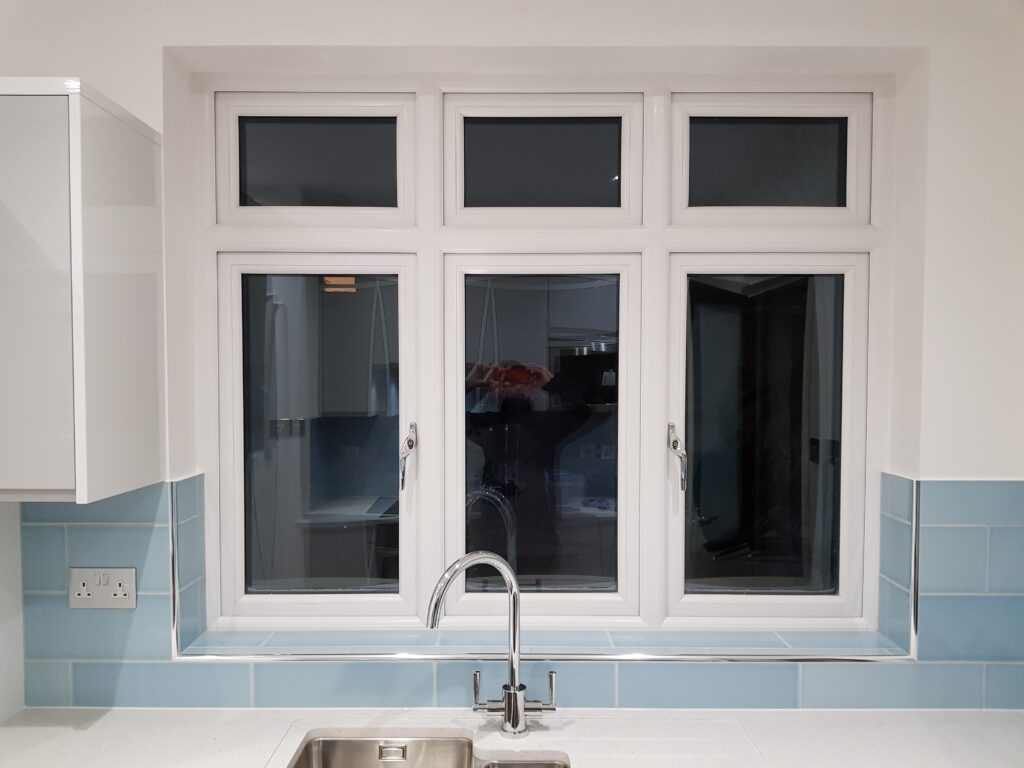 Professional kitchen installation in Mill Hill featuring a blue metro tiles and a chrome kitchen tap as the main focal points