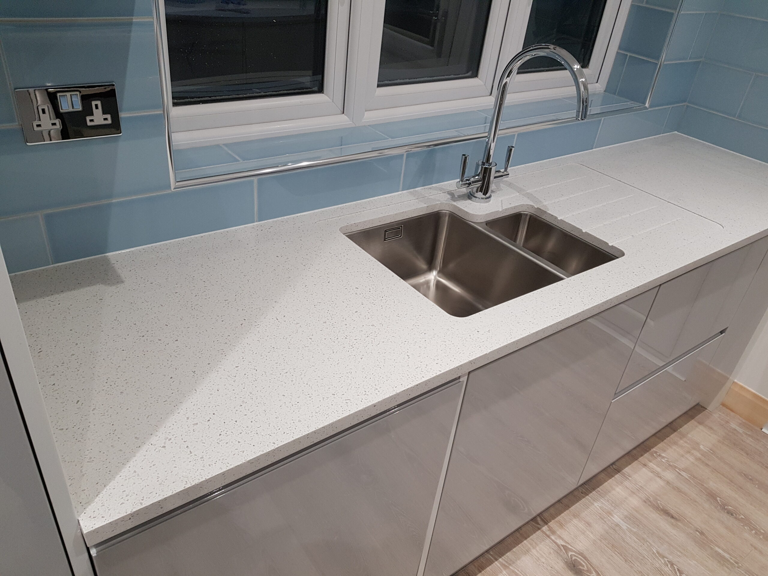 Kitchen with White Gloss Kitchen and  red Glass Splashback in Hadley Wood