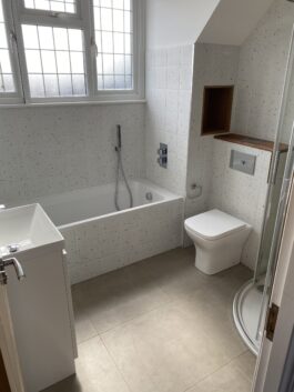 Professional bathroom installation in Arkley featuring a speckle porcelain tiles and a back to wall toilet as the main focal points. The design is completed with a concealed shower for a cohesive modern finish. Project completed by A Martens Kitchens & Bathrooms Ltd. For a free quote, visit https://amartens.co.uk to discuss your bathroom renovation. Professional bathroom installation in Arkley featuring a speckle porcelain tiles and a back to wall toilet as the main focal points