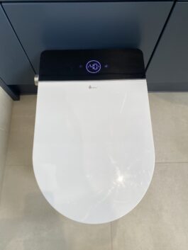 Professional wet room installation in Totteridge featuring a smart toilet and a blue bathroom vanity as the main focal points. The design is completed with a porcelain tiles for a cohesive modern finish. Project completed by A Martens Kitchens & Bathrooms Ltd. For a free quote, visit https://amartens.co.uk to discuss your wet room renovation. Professional wet room installation in Totteridge featuring a smart toilet and a blue bathroom vanity as the main focal points