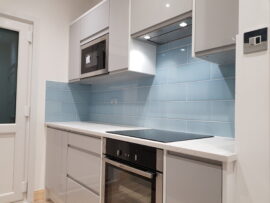 Professional kitchen installation in Mill Hill featuring a built-in oven and a blue metro tiles as the main focal points. The design is completed with a build-in microwave and a handleless kitchen for a cohesive modern finish. Project completed by A Martens Kitchens & Bathrooms Ltd. For a free quote, visit https://amartens.co.uk to discuss your kitchen renovation. Professional kitchen installation in Mill Hill featuring a built-in oven and a blue metro tiles as the main focal points