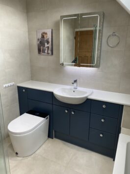 Professional wet room installation in Totteridge featuring a mirror cabinet and a smart toilet as the main focal points. The design is completed with a blue bathroom vanity and a semi recessed basin for a cohesive modern finish. Project completed by A Martens Kitchens & Bathrooms Ltd. For a free quote, visit https://amartens.co.uk to discuss your wet room renovation. Professional wet room installation in Totteridge featuring a mirror cabinet and a smart toilet as the main focal points