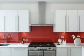 Professional kitchen installation in Hadley Wood featuring a luxury kitchen and a red glass splashback as the main focal points. The design is completed with a chimney hood and a freestanding range for a cohesive modern finish. Project completed by A Martens Kitchens & Bathrooms Ltd. For a free quote, visit https://amartens.co.uk to discuss your kitchen renovation. Professional kitchen installation in Hadley Wood featuring a luxury kitchen and a red glass splashback as the main focal points.