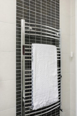 Professional bathroom installation in Mill Hill featuring a chrome towel rail and a black mosaic tiles as the main focal points. The design is completed with a porcelain tiles for a cohesive modern finish. Project completed by A Martens Kitchens & Bathrooms Ltd. For a free quote, visit https://amartens.co.uk to discuss your bathroom renovation. Professional bathroom installation in Mill Hill featuring a chrome towel rail and a black mosaic tiles as the main focal points