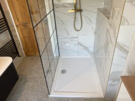 Professional bathroom installation in Hadley Wood featuring a rectangle shower tray and a marble tiles as the main focal points. The design is completed with a black shower screen for a cohesive modern finish. Project completed by A Martens Kitchens & Bathrooms Ltd. For a free quote, visit https://amartens.co.uk to discuss your bathroom renovation. Professional bathroom installation in Hadley Wood featuring a rectangle shower tray and a marble tiles as the main focal points