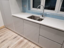 Professional kitchen installation in Mill Hill featuring an under mount sink and a corian worktop as the main focal points. The design is completed with a handleless kitchen and a wood flooring for a cohesive modern finish. Project completed by A Martens Kitchens & Bathrooms Ltd. For a free quote, visit https://amartens.co.uk to discuss your kitchen renovation. Professional kitchen installation in Mill Hill featuring an under mount sink and a corian worktop as the main focal points