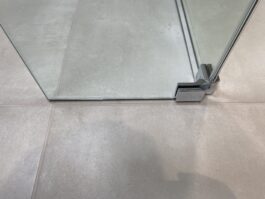 Professional wet room installation in Totteridge featuring a beige tiles and a hinged deflector panel as the main focal points. Project completed by A Martens Kitchens & Bathrooms Ltd. For a free quote, visit https://amartens.co.uk to discuss your wet room renovation. Professional wet room installation in Totteridge featuring a beige tiles and a hinged deflector panel as the main focal points