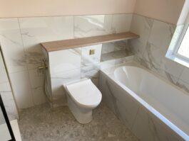 Professional bathroom installation in Hadley Wood featuring a back to wall toilet and a marble tiles as the main focal points. The design is completed with a single ended bath and a toilet spray for a cohesive modern finish. Project completed by A Martens Kitchens & Bathrooms Ltd. For a free quote, visit https://amartens.co.uk to discuss your bathroom renovation. Professional bathroom installation in Hadley Wood featuring a back to wall toilet and a marble tiles as the main focal points